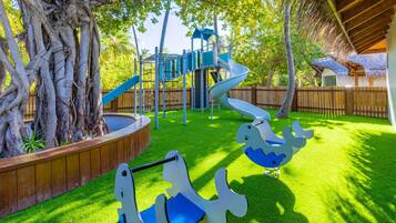 A playground with a slide, climbing structures, and swings.