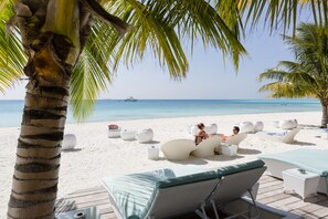 On the beach, white sand, beach towels, scuba diving
