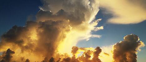 Un atardecer sobre el océano con nubes.