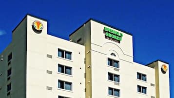 A multi-story hotel with a prominent sign for 'EMERALD SHORES' on the facade.