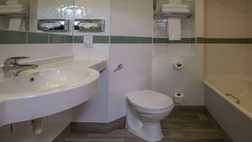 A bathroom with a sink, toilet, and bathtub.