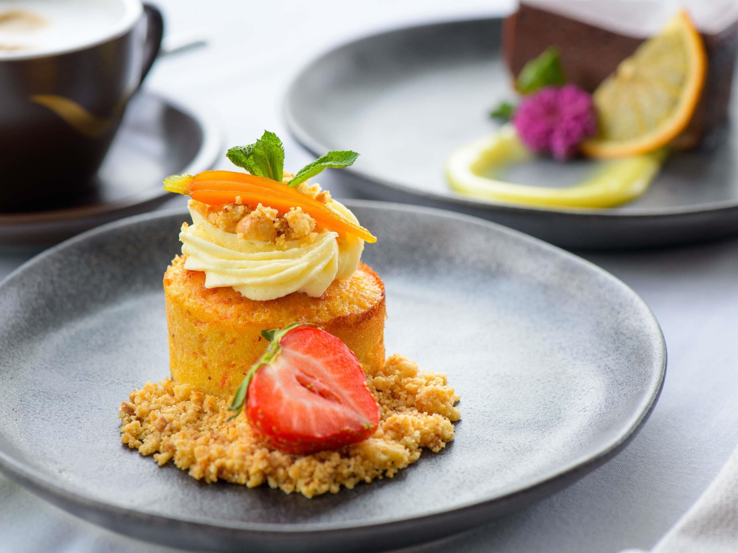A dessert with a strawberry on a plate.
