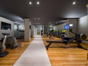 A gym with treadmills, stationary bikes, and weight machines.