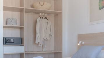 A neatly organized bedroom with a bed, a wardrobe, and a bedside table.