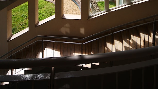 A multi-level interior with a central staircase, large windows, and balconies. - Akacfa Holiday Apartments (Budapest)