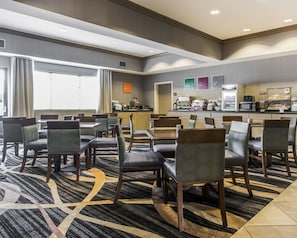 Enjoy meals in the dining area with a large window and comfortable seating.