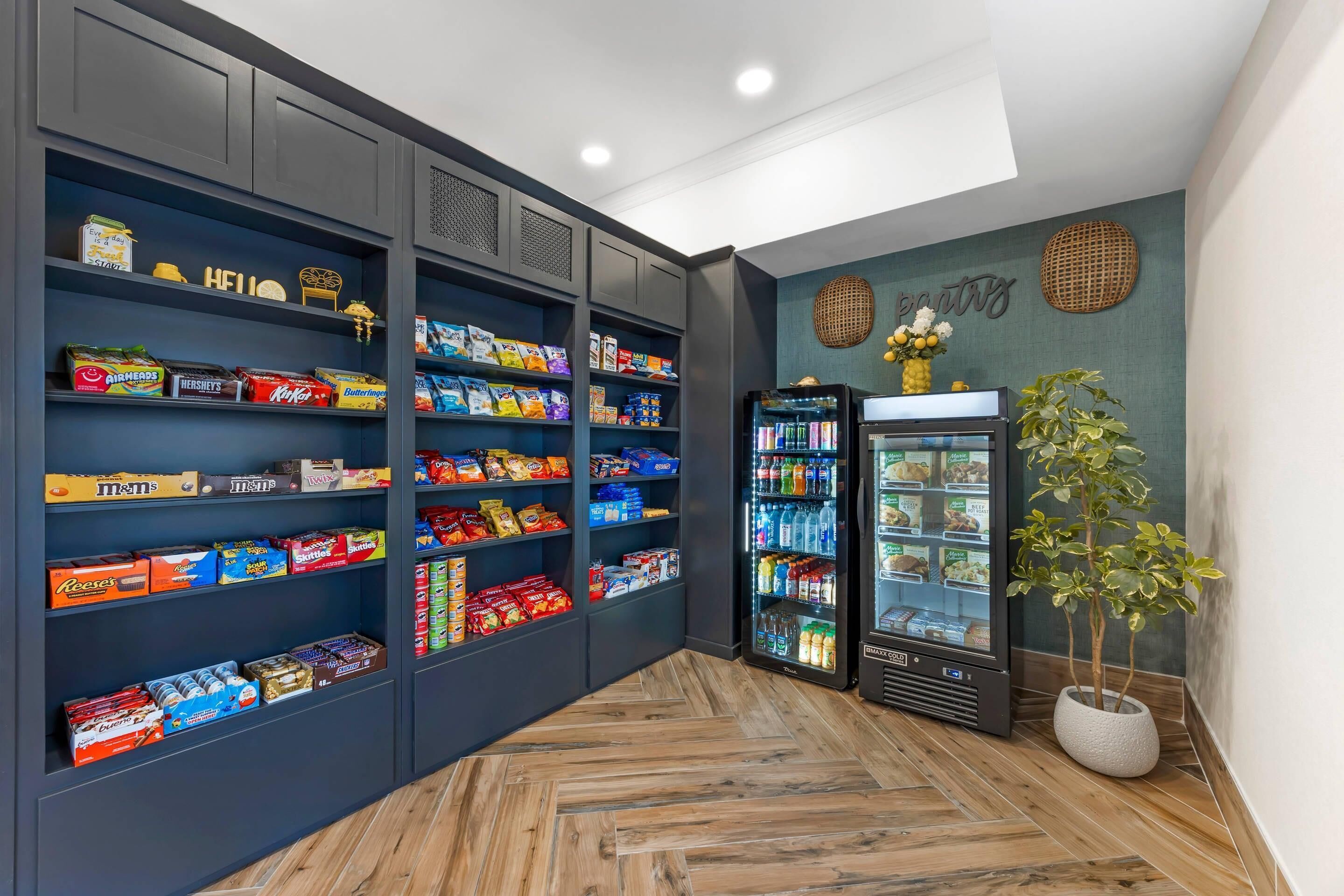 A snack bar with shelves stocked with various packaged snacks and a refrigerated display case.