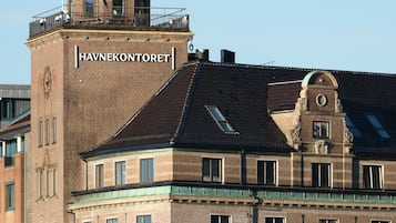 A historic building with a prominent clock tower and the name "HAVNEKONTORTOR" on its facade.