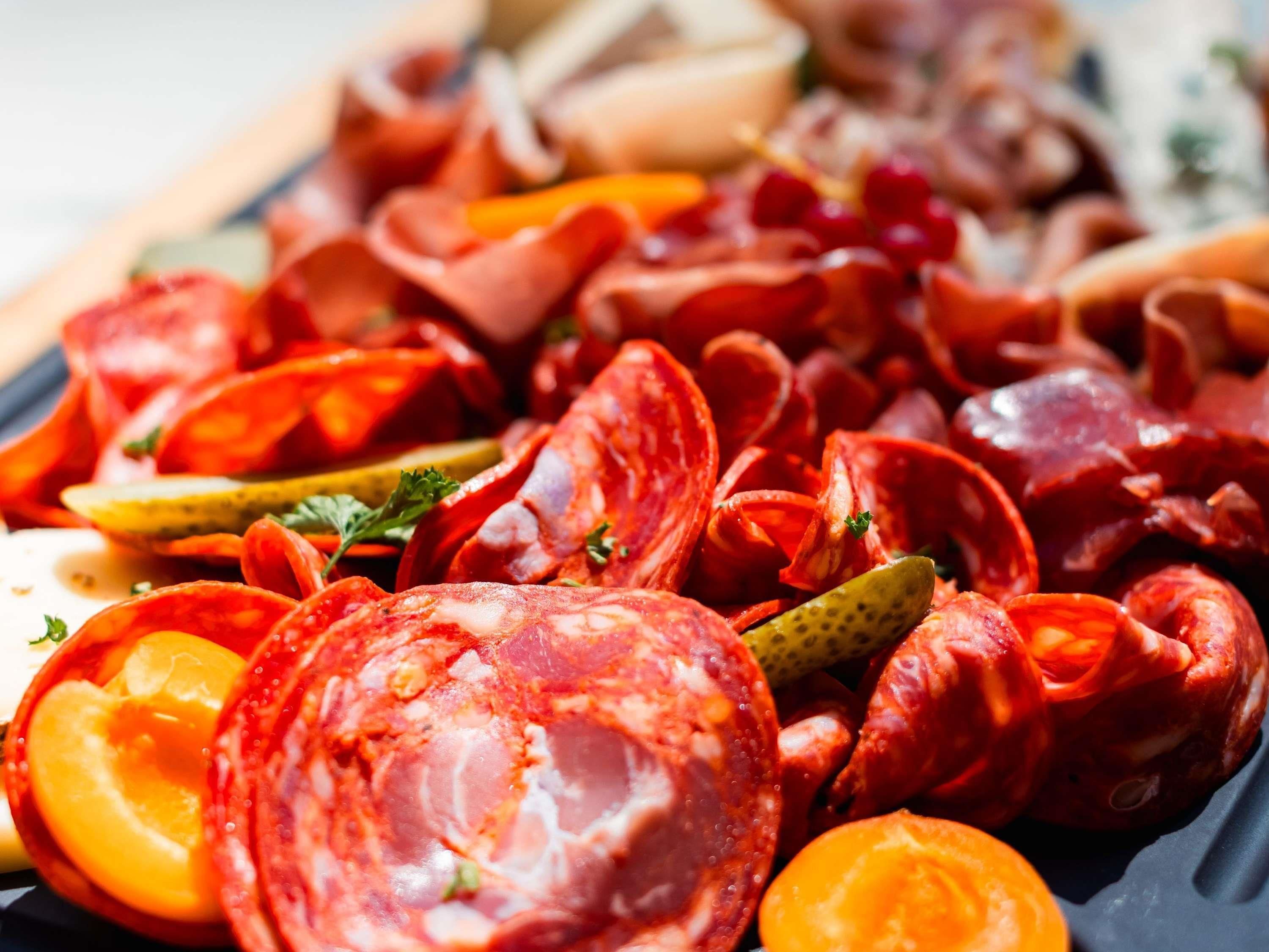 A platter of various cured meats and pickles.
