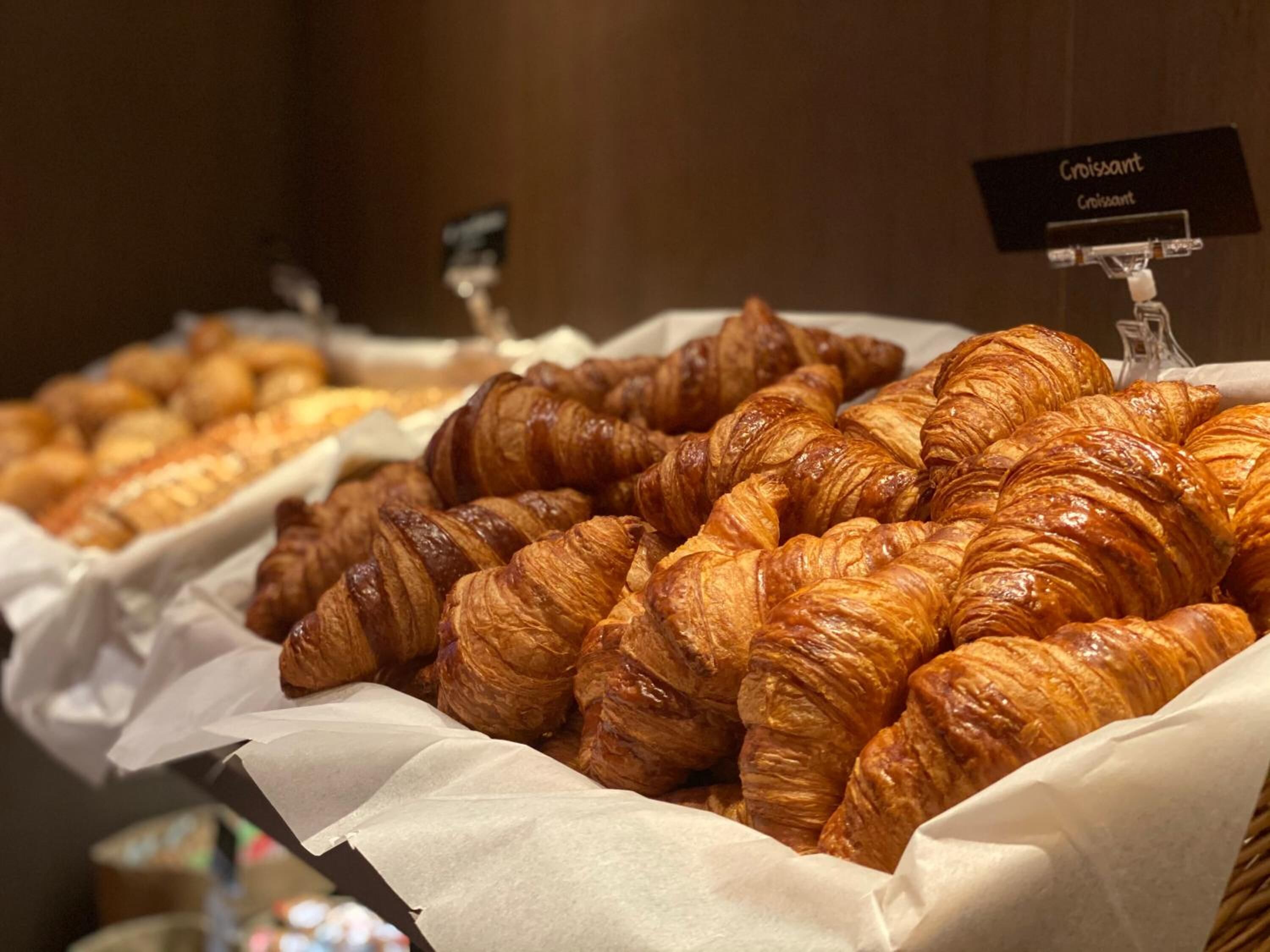 A display of croissants in a bakery section.