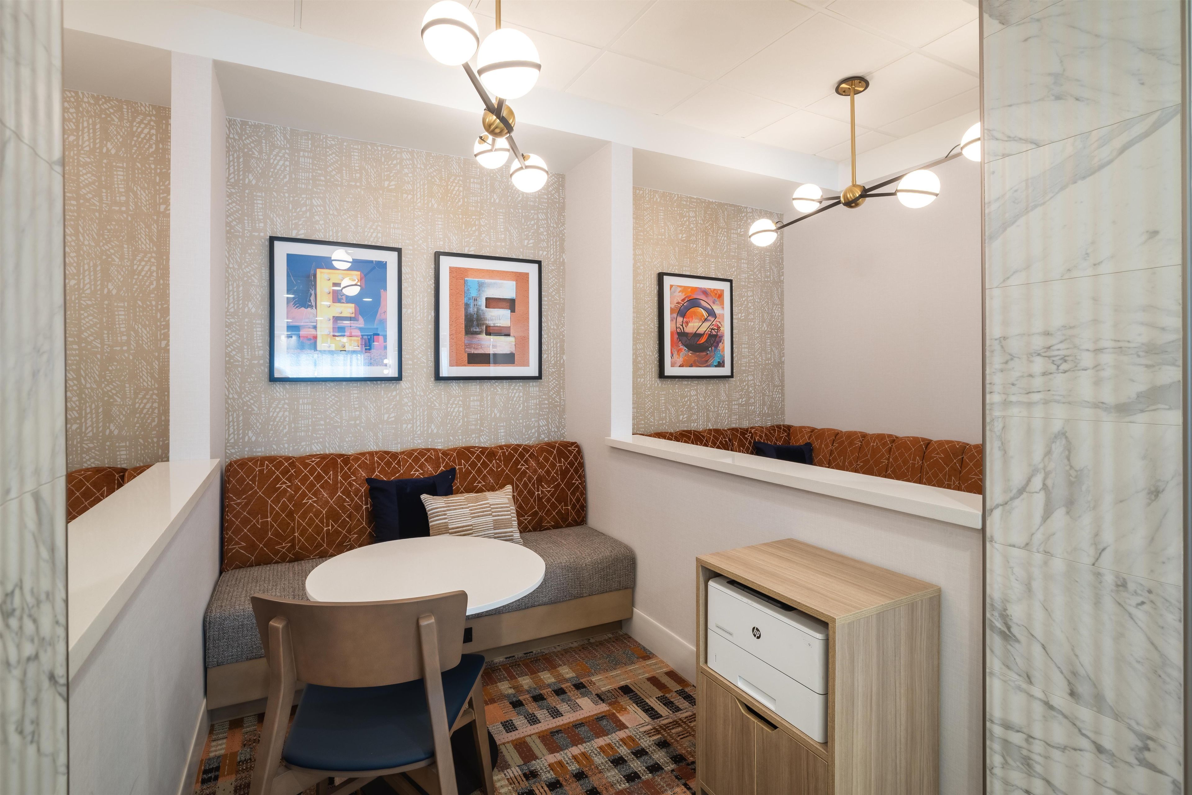 A modern kitchenette with a built-in oven, a sink, and a countertop.