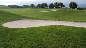 A golf course with sand bunkers, green fairways, and trees. - Staybridge Suites Lake Forest by IHG (Foothill Ranch)