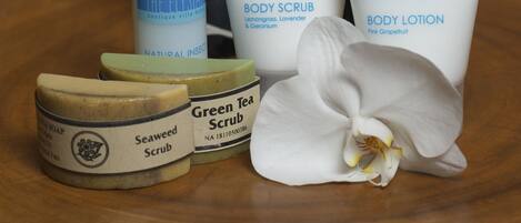 Un espace de bien-être avec des bougies, des produits de soins pour le corps et une orchidée.