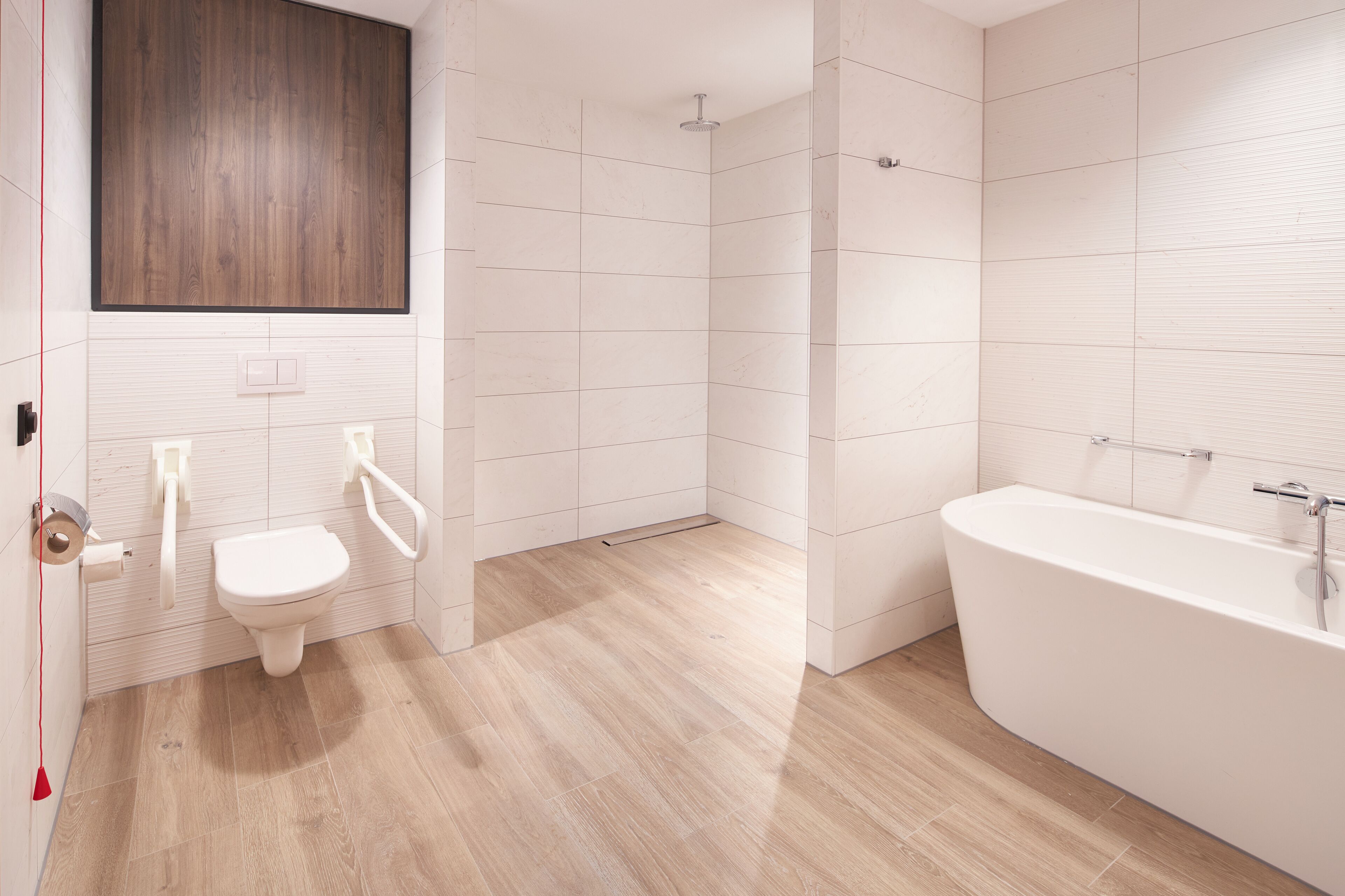 A modern bathroom with a toilet, bidet, shower, and bathtub.