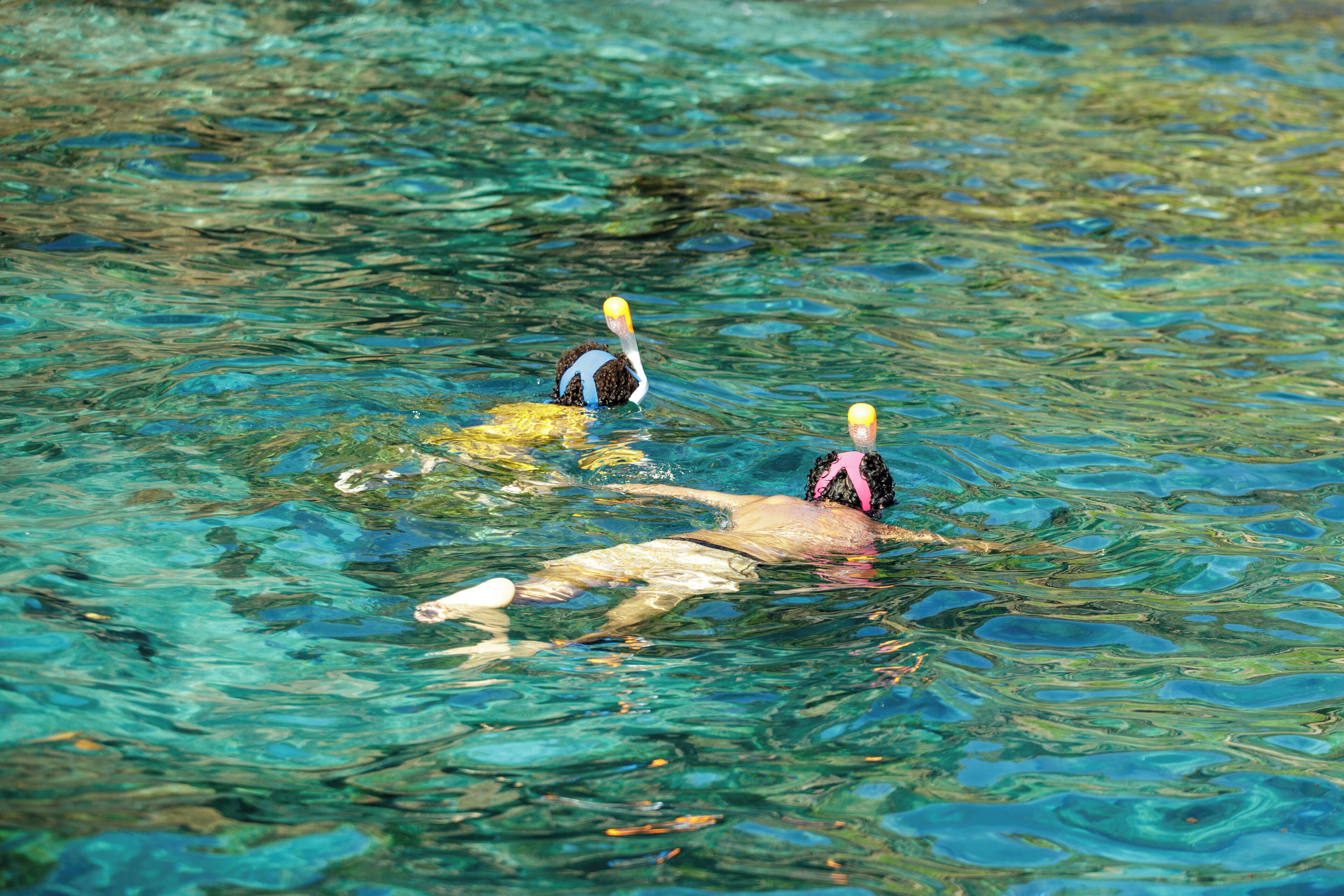 A person swimming in clear water.