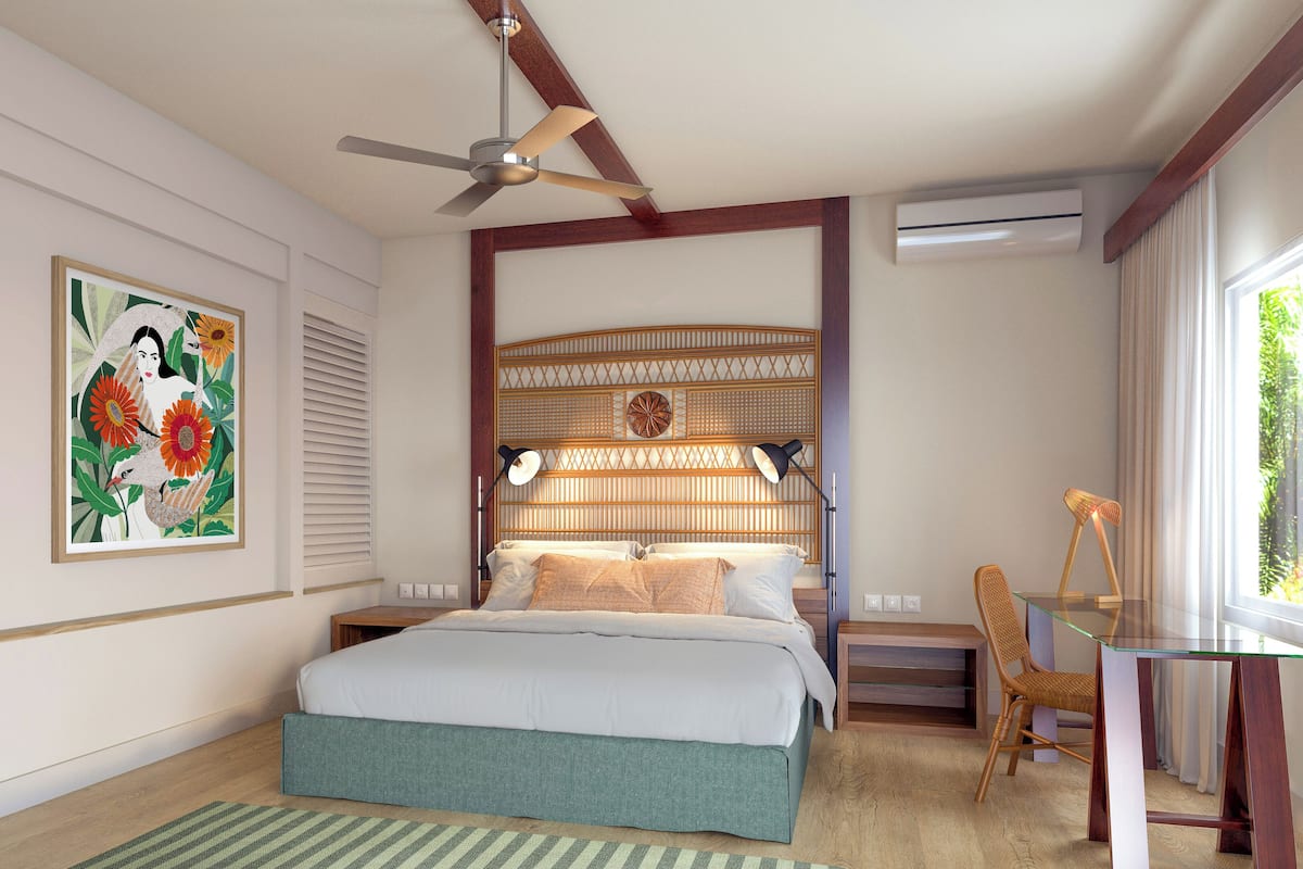A bedroom with a bed, a ceiling fan, a wall-mounted air conditioner, a window with curtains, and a framed picture on the wall.