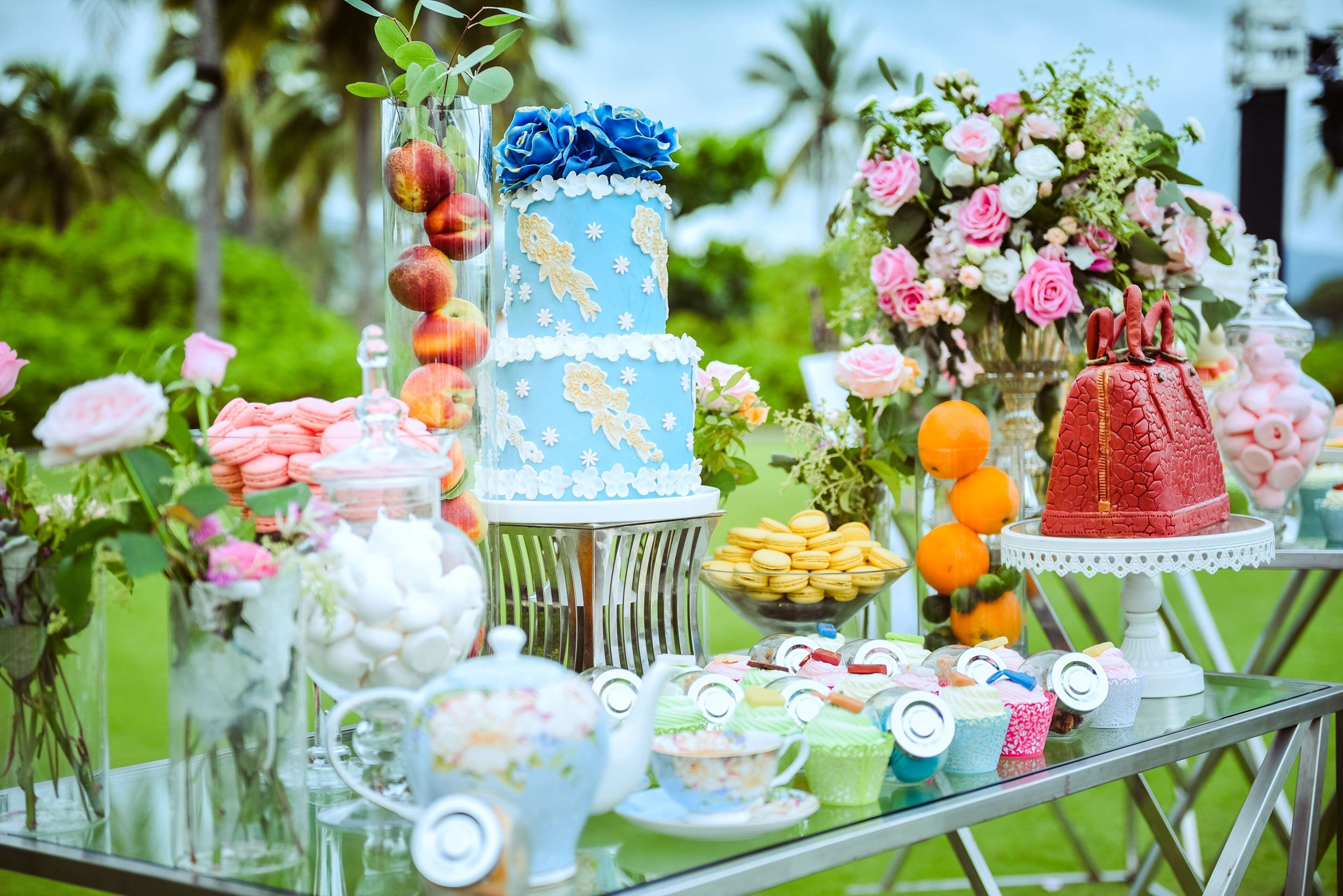 A dessert table with various pastries, macarons, and a tiered cake.