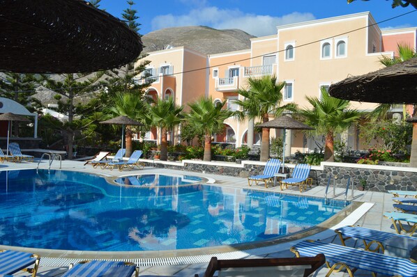 Seasonal outdoor pool, open 6:00 AM to 9:00 PM, pool umbrellas
