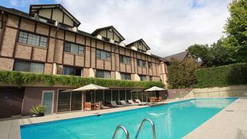 Relax by the pool surrounded by lush greenery and take in the views from the large windows of this hotel.