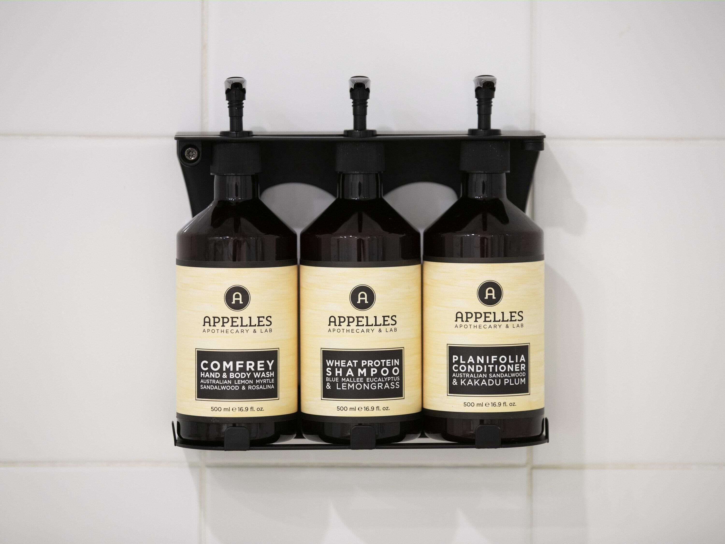 Three bottles of APPELLES products: COMFREY hand and body wash, WHEAT PROTEIN SHAMPOO, and PLANIEOLIA conditioner.