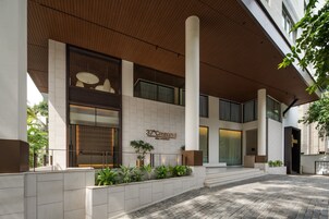 A modern building with a sign reading "37°Crescent Stay Revitalized".