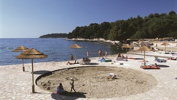 On the beach, sun loungers, beach umbrellas, beach volleyball