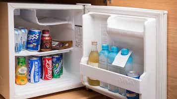 An open refrigerator with various beverages and cans.
