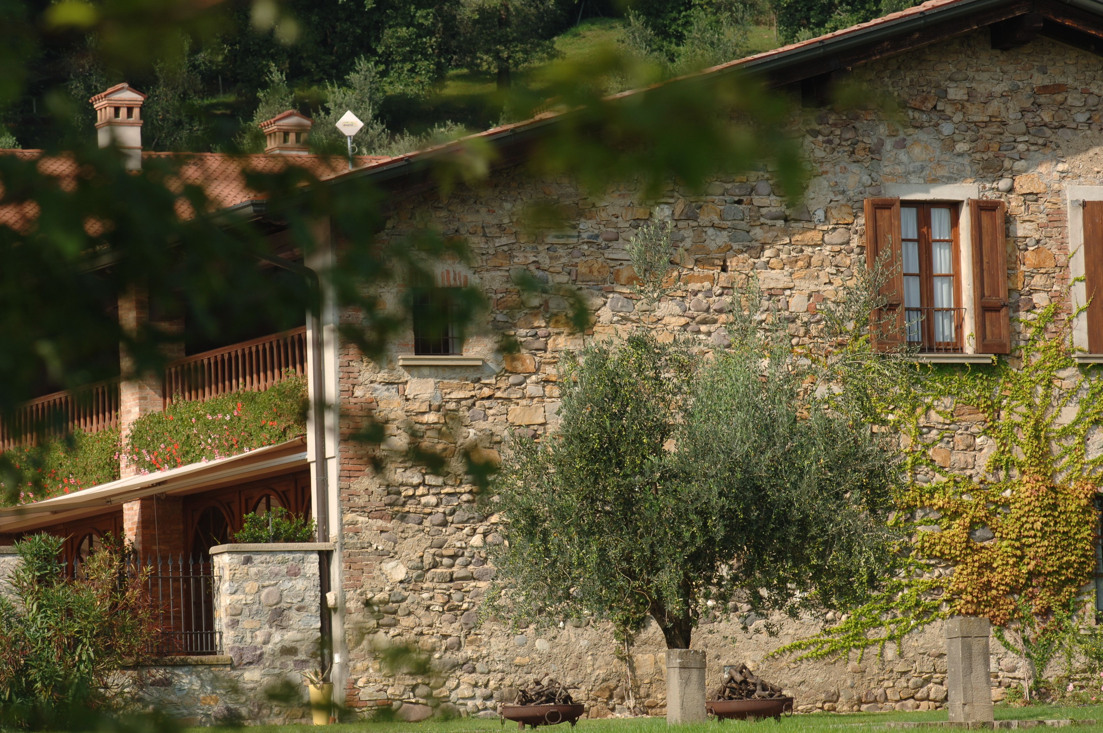 A stone building with a wooden balcony and a stone wall.
