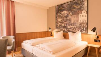A hotel room with a double bed, two bedside tables, a chair, and a large historical painting on the wall.