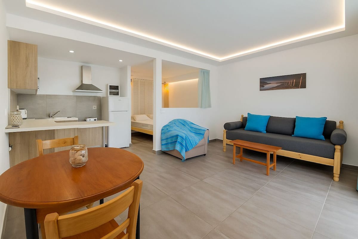 Family Apartment, Pool View, Ground Floor | Living area | 27-inch LCD TV with digital channels