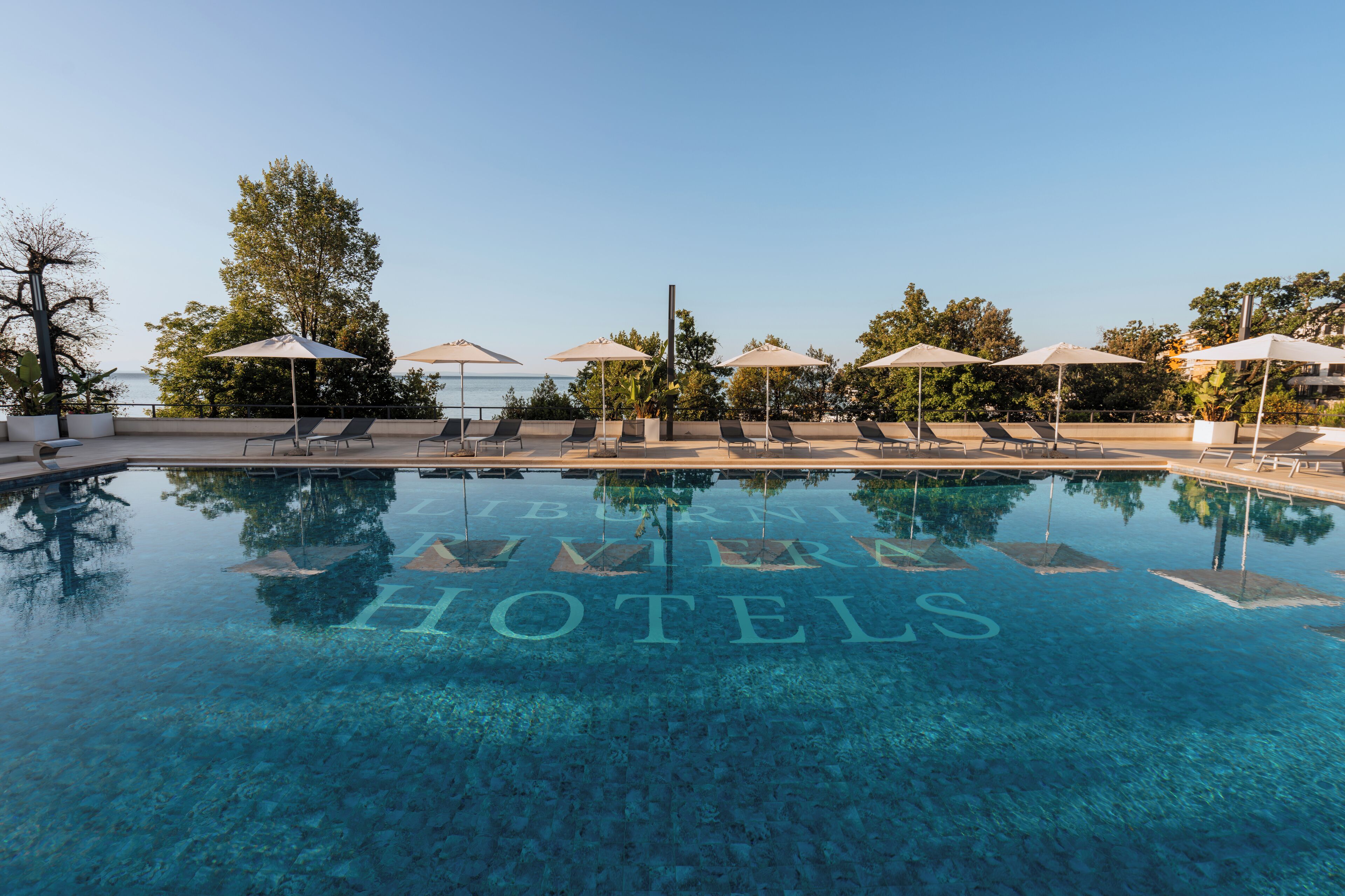 indoor pool, seasonal outdoor pool, pool umbrellas, pool loungers