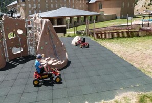 A playground with climbing structures and a covered seating area. - Vall de Nuria (Queralbs)