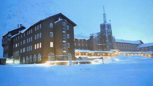 A large building with multiple windows and a prominent tower structure. - Vall de Nuria (Queralbs)