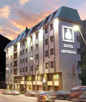 A multi-story hotel building with a prominent sign reading 'HOTEL IMPERIAL.'