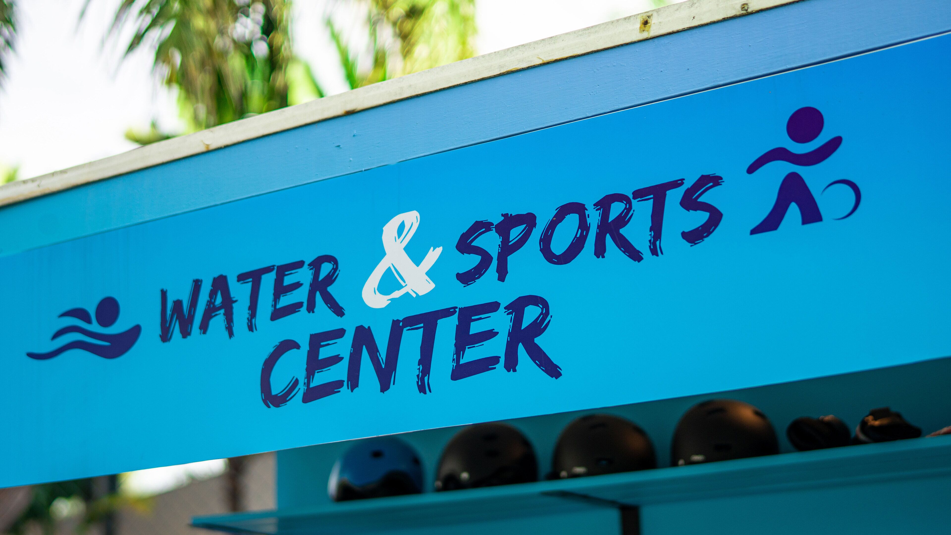 A sign for a Water & Sports Center with a swimming icon and a running icon.