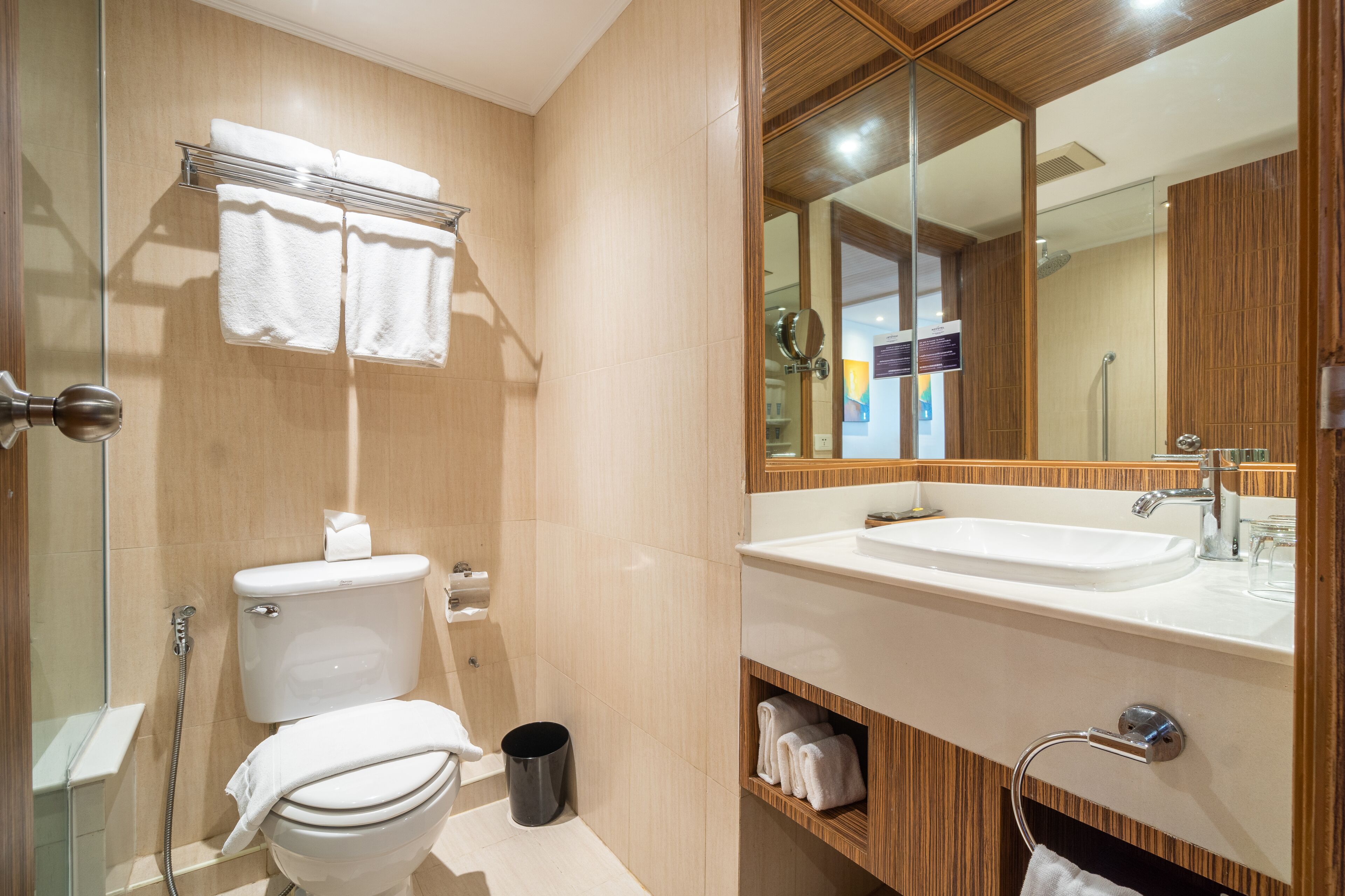 A modern bathroom with a toilet, sink, and shower.