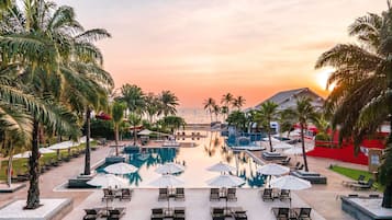Una piscina al aire libre, camas de piscina gratis, sombrillas