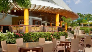 An outdoor patio area with wicker furniture and a covered seating area. - Marco Polo Plaza Cebu (Cebu City)
