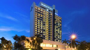 A high-rise hotel building with multiple floors, a prominent sign at the top, and a well-lit facade. - Marco Polo Plaza Cebu (Cebu City)