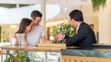 A reception desk with a sign that reads "CONCIERGE".