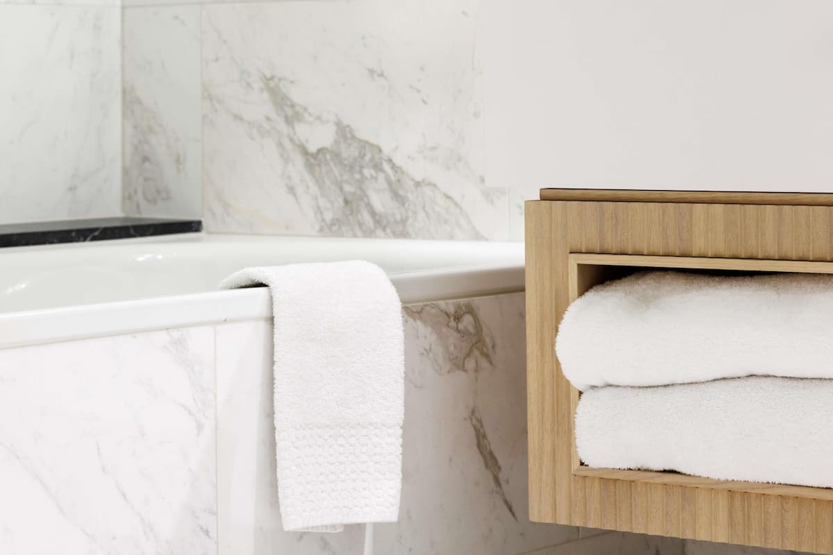 Deep-soaking bathtub, rainfall showerhead, designer toiletries