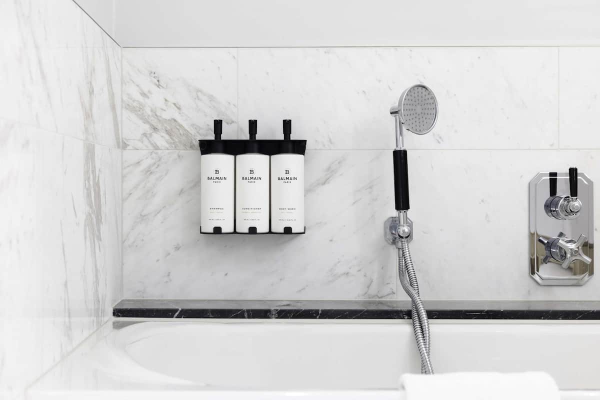 Deep-soaking bathtub, rainfall showerhead, designer toiletries