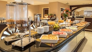 A buffet setup with various food items and serving stations. - VIP Grand Maputo (Maputo)