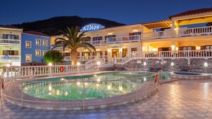 A hotel with a swimming pool, multiple balconies, and a sign that reads "Açores". - Aeolos Hotel (Skopelos)