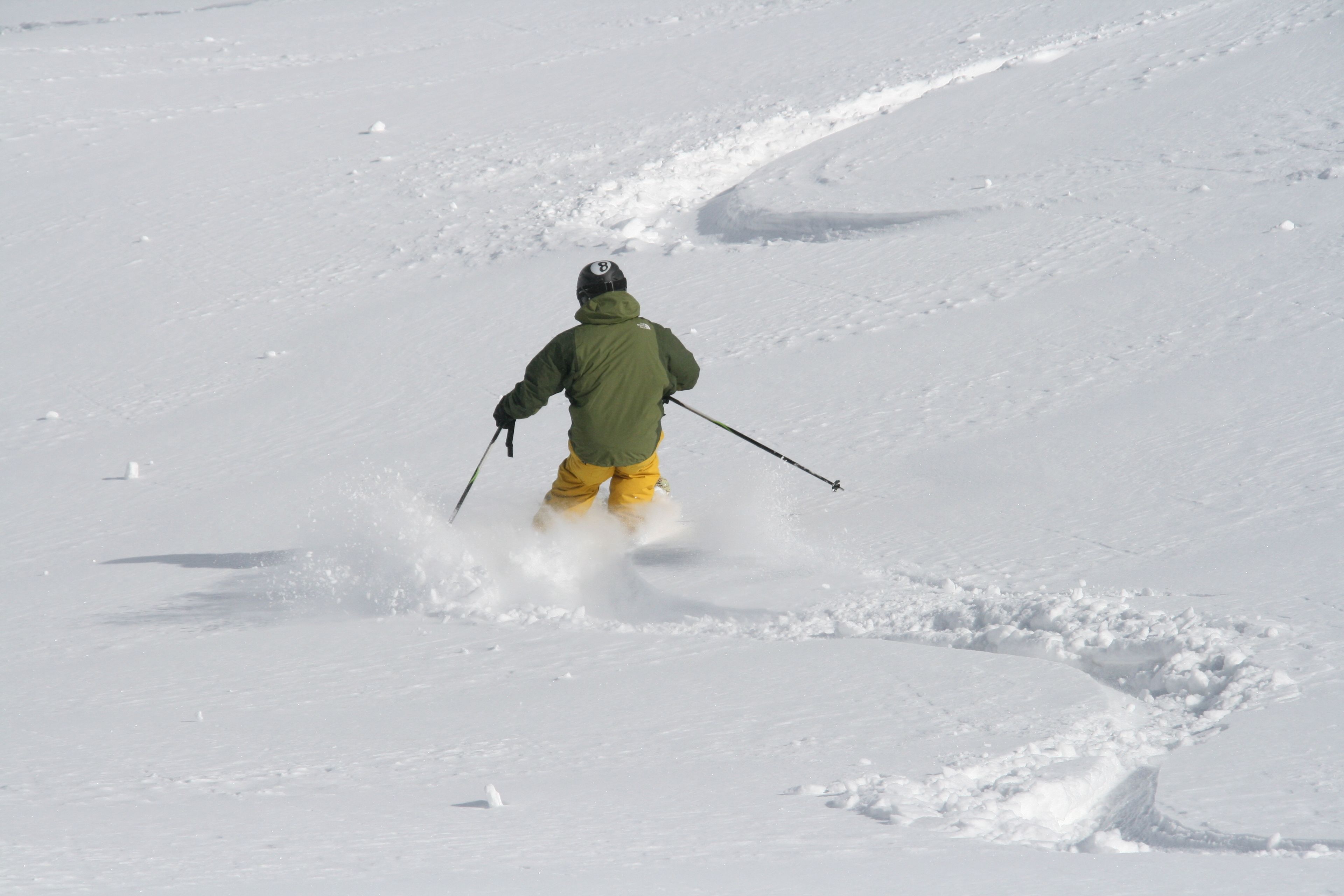 A person skiing down a snowy slope.