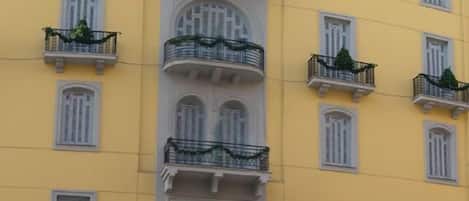 A yellow building with balconies and a sign that reads "EDEN".