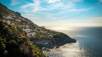 A coastal town with buildings on a hillside overlooking the sea.