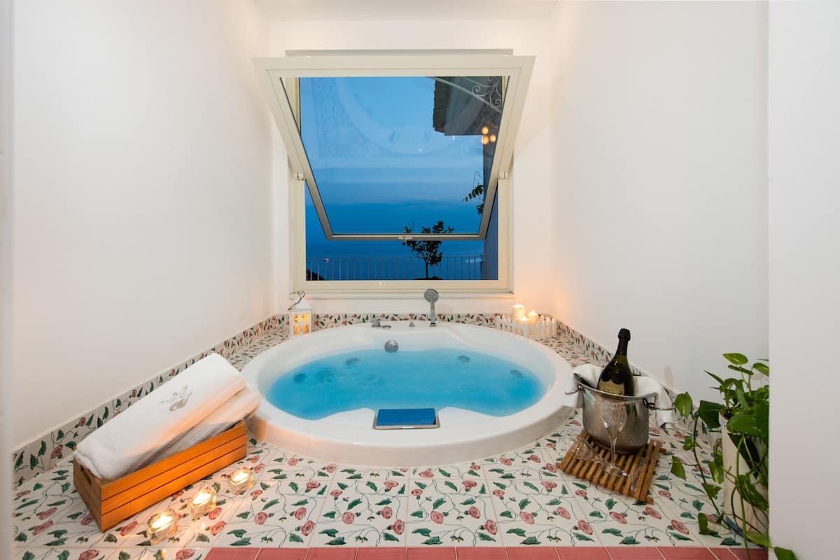 romantic suite, 1 king bed, hot tub, sea view | private spa tub