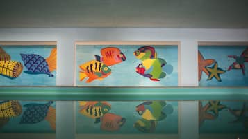 A series of framed fish paintings on a wall.