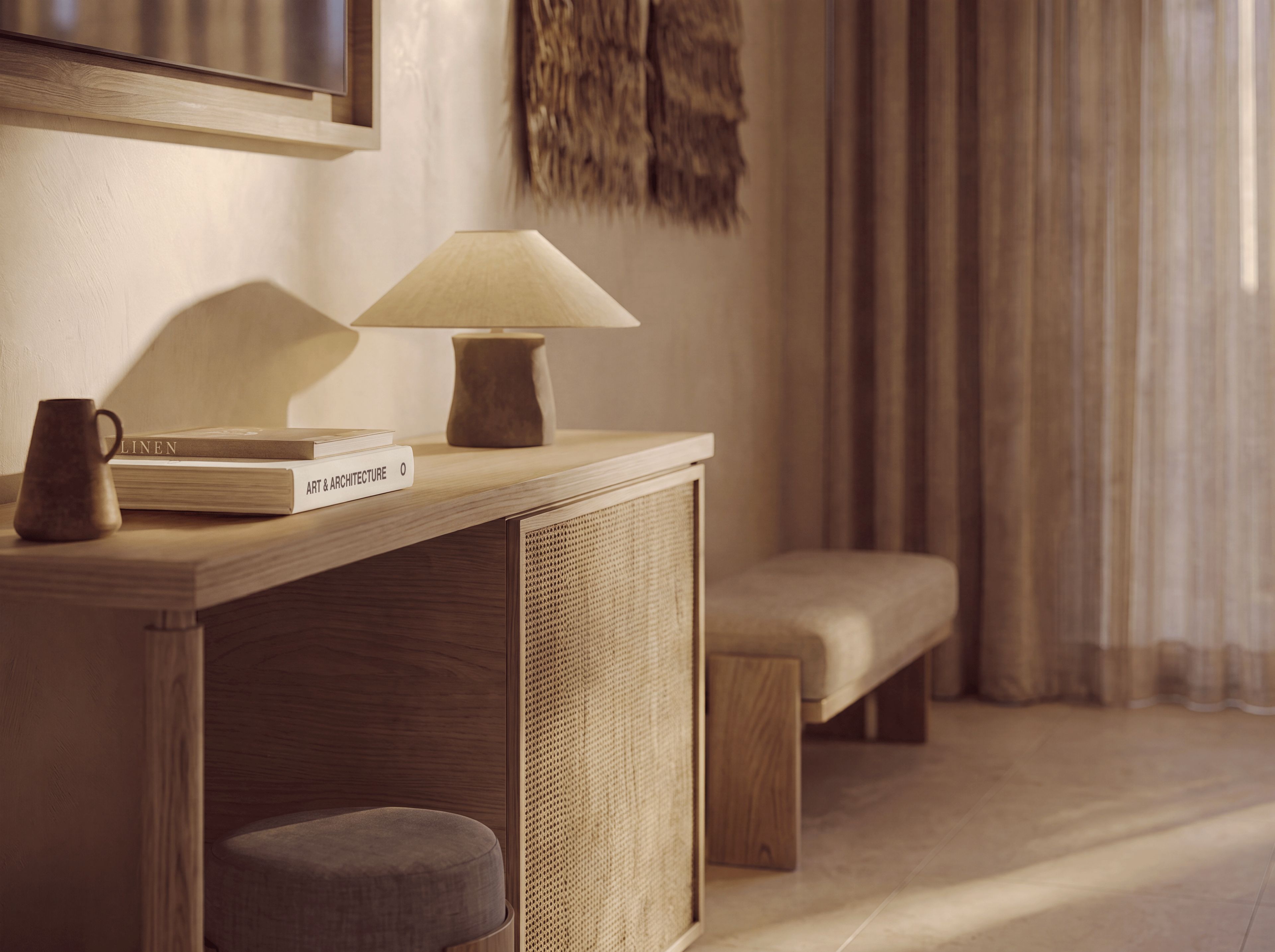 A wooden console table with a lamp, a book titled 'ART & ARCHITECTURE,' and a small stool.